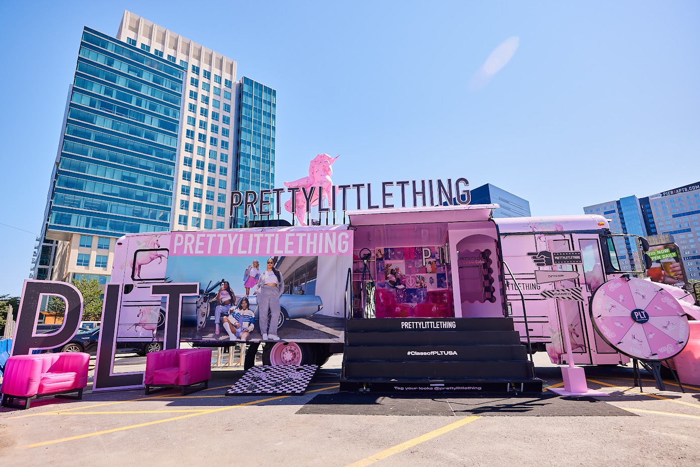 The PLT tour bus, with tall buildings behind